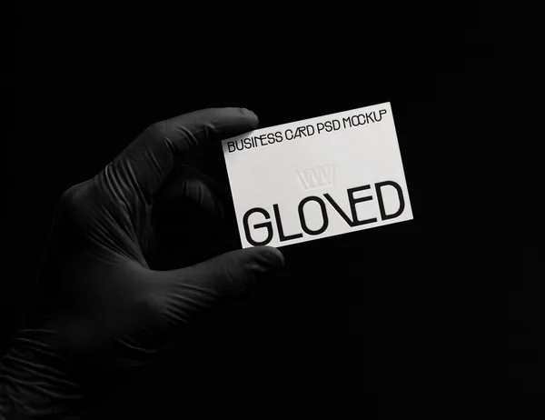 Gloved Hand Holding Business Card Stationery PSD Mockup