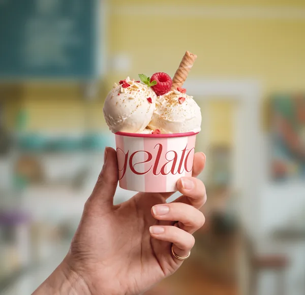 Hand Holding Gourmet Ice Cream Paper Cup PSD Mockup