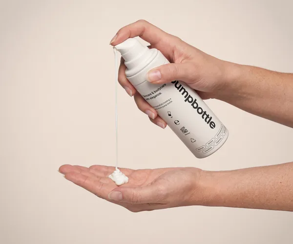 Aesthetic Cosmetic Pump Cream Bottle with Hand Action PSD Mockup
